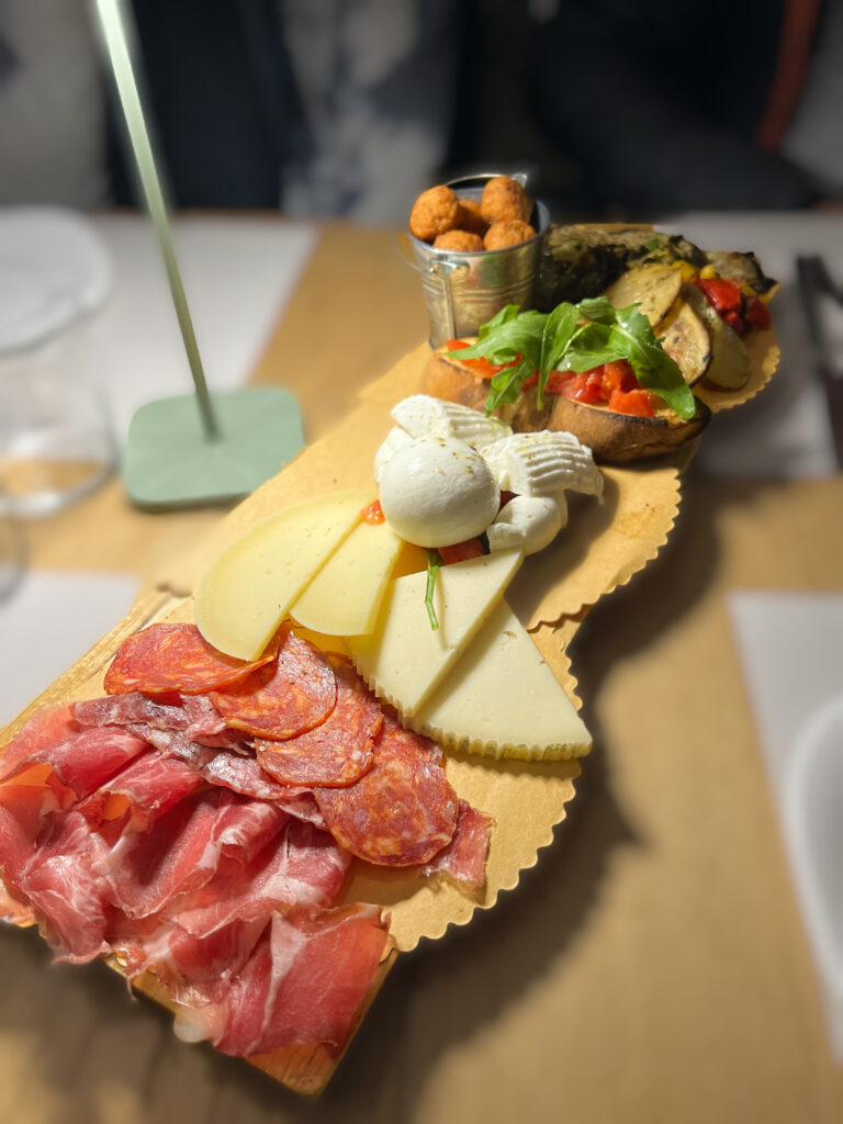 A taglieri board with regional produce from Puglia including salami, burrata and cold cuts shows Puglia cooking class - Eat Puglia by the Puglia Guys