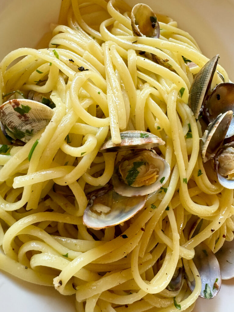 Spaghetti alle vongole recipe by the Puglia Guys. Spaghetti alle vongole is a dish that captures the essence of our summer. It speaks of family and friends gathered together for a lazy lunch by the seaside, or at home. The light and fresh flavours make it ideal for hot days as well as balmy nights.