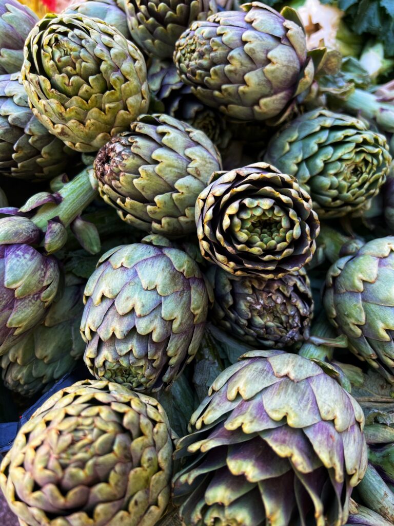 Artichokes for sale on one of Puglia’s daily market stalls. The Puglia Kitchen by the Puglia Guys.