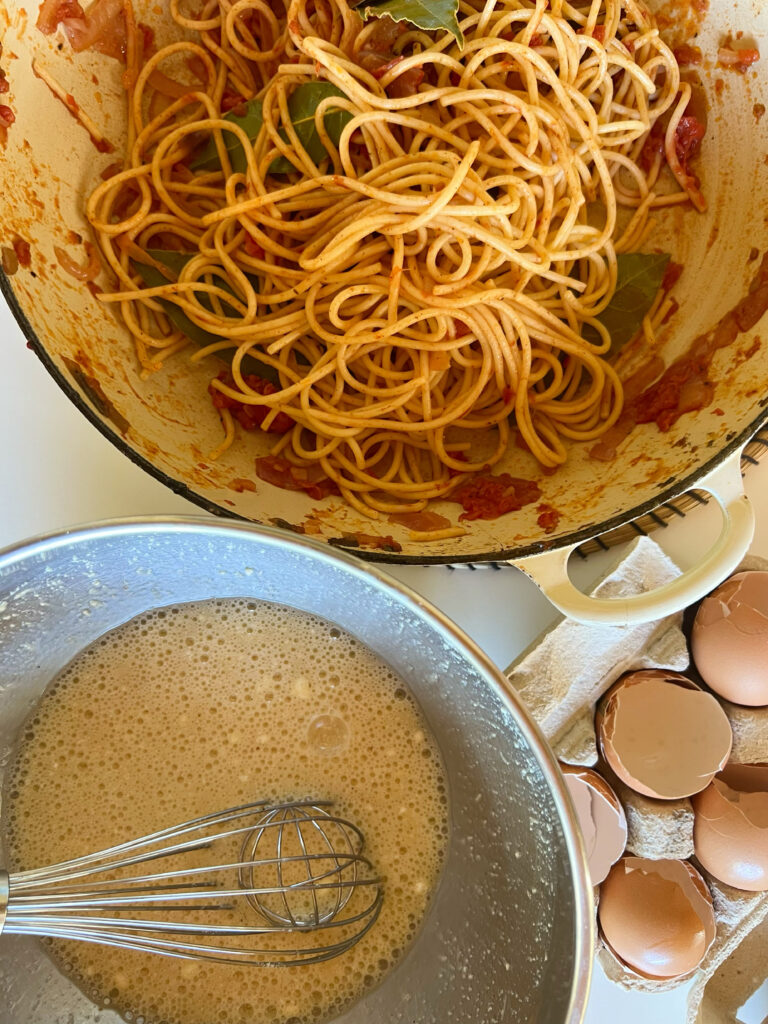 Leftover spaghetti and beaten eggs for Spaghetti frittata recipe from the Puglia Kitchen by the Puglia Guys. 