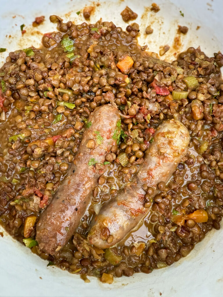 For our vigilia di Capodanno New Year’s Eve meal they’re usually served up with cotechino, a fatty and aromatic sausage that is laced with pork skin and spices. However, the cotechino is not always to everyone’s taste, and a more modern take is to serve the lentils with pork sausages (pork is also a symbol of abundance) instead. The Puglia Kitchen by the Puglia Guys.