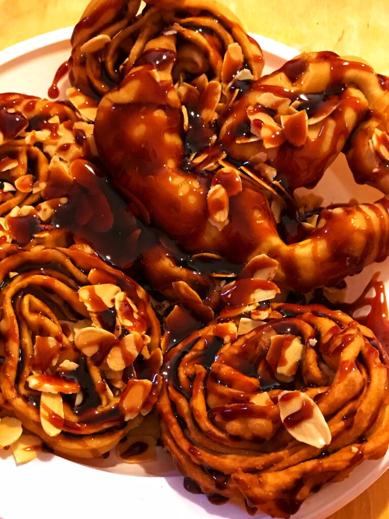 Cartellate covered with vincotto and flaked almonds. Photo by the Puglia Guys, Puglia ambassadors. PugliaGuys.com