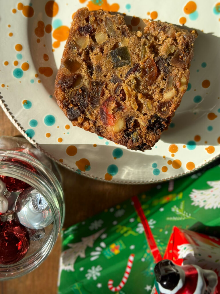 Leftover Christmas cake on a plate in the Puglia Kitchen for our version of TiramiYule, a crossover Christmas recipe that’s perfect for using up leftover Christmas cake. Photo by the Puglia Guys, Puglia ambassadors. PugliaGuys.com