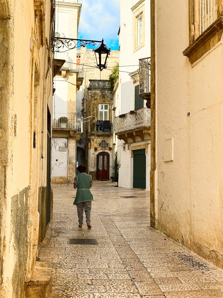 From The Puglia Guys Martina Franca Guide.

Martina is a town rich in Baroque elegance, historic charm, and cultural heritage. Walking through its winding streets, visitors encounter stunning churches, grand palaces, and picturesque piazzas, each telling a story of the town’s rich past. Our Puglia Guys Martina Franca guide takes you on a journey through the most remarkable sites, from the Gothic convents to the Baroque splendor of its churches and palazzi, with recommendations for the best local restaurants to complete your experience

Nestled in the picturesque Valle d’Itria, approximately halfway between the Ionian and Adriatic Seas, Martina Franca’s strategic position—which allowed for control over trade and commerce, a key factor in the town’s prosperity—played a crucial role in shaping its past, from ancient settlements to medieval fortifications and Baroque splendour. 

For history lovers, art enthusiasts, and cultural explorers, Martina’s churches offer a glimpse into a time when faith and art were inextricably linked, creating monuments that continue to inspire and captivate.

Today, Martina Franca is a vibrant town, the largest of the Valle d’Itria. Its charm lies in its baroque architecture, splendid churches, the narrow streets of its old town, and 18th-century town houses with Baroque features and wrought-iron balconies. Known for its gastronomy (we recommend some of our favourite restaurants, but in reality there is no need to adhere to it, good food is easy to find) its best known culinary export capocollo di Martina Franca (our favourite regional cured meat).

Photo by the Puglia Guys, Puglia Travel ambassadors. PugliaGuys.com
